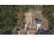 Aerial view of the property featuring a home, long driveway, and surrounding wooded area at 680 Jasmine Rd, Fuquay Varina, NC 27526