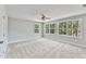 A bedroom with carpeted floors, neutral walls, and a ceiling fan for added comfort at 680 Jasmine Rd, Fuquay Varina, NC 27526