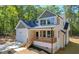 Stunning two-story home featuring a cozy front porch with natural wood posts and a two-car garage at 680 Jasmine Rd, Fuquay Varina, NC 27526