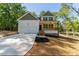 Inviting two-story home with a two-car garage, green front yard, and a welcoming entrance at 680 Jasmine Rd, Fuquay Varina, NC 27526