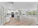 Spacious living room and kitchen with white cabinetry, stainless appliances, and an open floor plan at 680 Jasmine Rd, Fuquay Varina, NC 27526