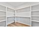 A simple white walk-in closet provides an open and customizable storage space at 680 Jasmine Rd, Fuquay Varina, NC 27526