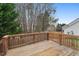 A spacious wooden back deck overlooks a backyard with mature trees at 7 Starwood Ln, Durham, NC 27712