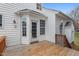 A wooden back deck and entrance to a white-sided house with a wooden railing at 7 Starwood Ln, Durham, NC 27712