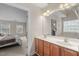 Dual sink bathroom vanity adjacent to a bedroom at 7 Starwood Ln, Durham, NC 27712