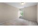Neutral bedroom featuring a window and wall to wall carpet at 7 Starwood Ln, Durham, NC 27712