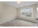 Bedroom with carpet and a large window at 7 Starwood Ln, Durham, NC 27712