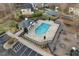 Aerial view of the fenced community pool with a playground and seating areas at 7 Starwood Ln, Durham, NC 27712