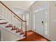 Bright foyer with hardwood floors, white trim and a staircase leading to the upper level at 7 Starwood Ln, Durham, NC 27712