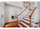 Elegant staircase and hardwood floors lead to a light-filled home office at 7 Starwood Ln, Durham, NC 27712