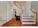 Inviting foyer features gleaming hardwood floors and a staircase with wooden railings at 7 Starwood Ln, Durham, NC 27712