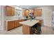 Bright and modern kitchen features wooden cabinets, an island with seating, and stainless steel appliances at 7 Starwood Ln, Durham, NC 27712