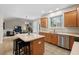 Well-lit kitchen with wooden cabinets, stainless steel appliances, an island, and seamless access to the living room at 7 Starwood Ln, Durham, NC 27712