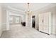 Open living room showcasing elegant columns, neutral color palette, and a glimpse into the modern kitchen at 7 Starwood Ln, Durham, NC 27712