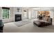 Inviting living room with a fireplace, comfortable seating, and seamless flow into the kitchen and dining area at 7 Starwood Ln, Durham, NC 27712