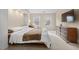 Bright main bedroom with large windows, plush carpeting, and cozy seating area, creating a peaceful oasis at 7 Starwood Ln, Durham, NC 27712