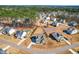 Aerial shot of neighborhood showcasing houses, landscaping, and community layout in a wooded area at 8132 Baronleigh Ln, Wake Forest, NC 27587