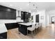 Modern kitchen featuring a large island, stainless steel appliances, and sleek black cabinets at 8132 Baronleigh Ln, Wake Forest, NC 27587