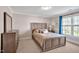 Bedroom with beige walls, light carpet, a wood-framed bed, and a window letting in natural light at 81517 Alexander, Chapel Hill, NC 27517