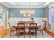 Elegant dining room with stylish chandelier, wainscoting, and plenty of natural light at 81517 Alexander, Chapel Hill, NC 27517