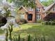 Charming brick home featuring a manicured lawn and inviting front entrance with decorative white flowers at 81517 Alexander, Chapel Hill, NC 27517