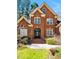 Charming two-story red brick home with a decorative front door and a beautifully landscaped yard at 81517 Alexander, Chapel Hill, NC 27517