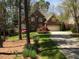 Charming two-story red brick home featuring a well-manicured lawn and a spacious two-car garage at 81517 Alexander, Chapel Hill, NC 27517