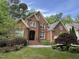 Charming two-story red brick home featuring a well-manicured lawn and a spacious two-car garage at 81517 Alexander, Chapel Hill, NC 27517