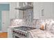 Modern kitchen with marble countertops, stainless steel range hood, and a professional-grade gas range at 81517 Alexander, Chapel Hill, NC 27517