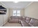 Living room with a plush leather sectional, carpeted floor, and natural light from a window at 81517 Alexander, Chapel Hill, NC 27517
