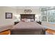 Luxurious main bedroom showcases a custom headboard, side tables, and ample natural light, creating a cozy ambiance at 81517 Alexander, Chapel Hill, NC 27517