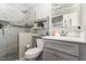 Bathroom with a shower with glass doors, gray vanity, toilet, and towel shelf stocked with fresh towels at 817 Roanoke Dr, Cary, NC 27513