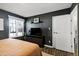 Bedroom featuring a modern TV console, window, and neutral decor at 8612 Keegan Ct, Raleigh, NC 27613