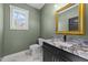 Bathroom with granite vanity, white toilet and decorative gold-framed mirror at 1019 Thompson Rd, Four Oaks, NC 27524