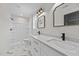 Modern bathroom with double vanity, marble floors, and a bright shower area at 1019 Thompson Rd, Four Oaks, NC 27524