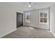 Sunlit bedroom with two windows and closet doors at 1019 Thompson Rd, Four Oaks, NC 27524