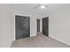 A tidy bedroom with a ceiling fan and a closet featuring dark doors at 1019 Thompson Rd, Four Oaks, NC 27524