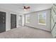 Bedroom with neutral carpeting, a ceiling fan, and natural light from two windows at 1019 Thompson Rd, Four Oaks, NC 27524