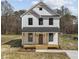 Charming two-story home with a welcoming front porch, board and batten siding and a modern farmhouse design at 1019 Thompson Rd, Four Oaks, NC 27524