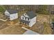 Aerial view of a modern farmhouse-style home with a covered front porch and white siding at 1019 Thompson Rd, Four Oaks, NC 27524