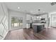 Stylish kitchen featuring white cabinets, stainless appliances, dark island and backyard access at 1019 Thompson Rd, Four Oaks, NC 27524