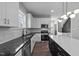 Beautiful kitchen features stainless appliances, white cabinets, dark countertops and a kitchen island at 1019 Thompson Rd, Four Oaks, NC 27524