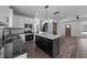 Bright kitchen with an island, modern lighting, stainless steel appliances, and ample counter space at 1019 Thompson Rd, Four Oaks, NC 27524