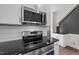 This modern kitchen features stainless steel appliances and white cabinets with dark countertops at 1019 Thompson Rd, Four Oaks, NC 27524