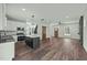 Spacious living room open to kitchen with island, stainless appliances, and wooden barn door at 1019 Thompson Rd, Four Oaks, NC 27524