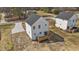 Aerial view of home's back exterior, featuring a wood deck with stairs and white siding at 1019 Thompson Rd, Four Oaks, NC 27524