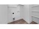 This is a small, basic utility room with white walls and wood-look floors at 1019 Thompson Rd, Four Oaks, NC 27524