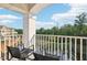 A nice balcony with seating and views of a pond and trees, perfect for relaxation and enjoying the scenery at 10320 Sablewood Dr # 107, Raleigh, NC 27617