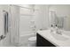 Neutral bathroom with a shower-tub combo, white shower curtain, and dark vanity, creating a clean and simple space at 10320 Sablewood Dr # 107, Raleigh, NC 27617