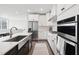 Modern kitchen with white cabinetry, stainless steel appliances, a gas cooktop, and an undermount sink at 10320 Sablewood Dr # 107, Raleigh, NC 27617